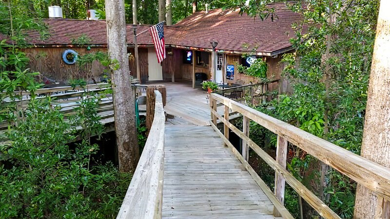 Boardwalk entrance to the TreeHouse Grill among the trees in Vidalia, Georgia